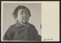 [recto] Sachi Chira, daughter of Sam Chira, Nisei, a resident at Heart Mountain, formerly a farmer in El Monte, California who specialized in the raising of strawberries. ;  Photographer: Parker, Tom ;  Heart Mountain, Wyoming.