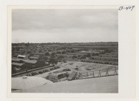 [recto] Bird's eye view of quarters for evacuees of Japanese ancestry at Santa Anita Park Assembly Center. Evacuees will be transferred later to War Relocation Authority Centers for the duration. ;  Photographer: Albers, Clem ;  Arcadia, California.