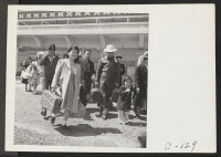 [recto] San Bruno, Calif.--Family of Japanese ancestry arrives at assembly center at Tanforan Race Track. Evacuees will be transferred later to War Relocation Authority centers where they will be housed for the duration. ;  Photographer: Lange, Dorothea ;  Sa