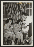 [recto] A farewell party being held in Block 17 in honor of the people leaving for Tule Lake Center. The general scene is where the girls are having refreshments. ;  Photographer: Okano, Tom K. ;  Dermott, Arkansas.