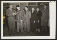 [recto] Chicago WRA supervisor, Elmer L. Shirrell, welcomes five resettlers who have come to the Midwest. From left to right as ...
