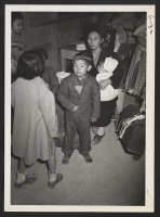 [recto] A segregee family awaits turn for processing. ;  Newell, California.