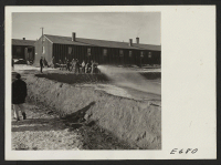 [recto] A crew of firemen and volunteer helpers man the fire house in flooding an ice skating rink at the Heart Mountain Relocation Center. ;  Photographer: Parker, Tom ;  Heart Mountain, Wyoming.