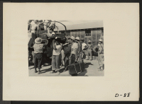 [recto] Eden, Idaho--Baggage, belonging to evacuees from the assembly center at Puyallup, Washington, is sorted and trucked to owners in their barrack apartments. ;  Photographer: Stewart, Francis ;  Hunt, Idaho.