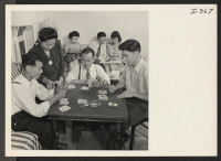 [recto] This group of New York City Nisei is spending a social evening in the living room of the uptown apartment ...