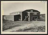 [recto] Closing of the Jerome Center, Denson, Arkansas. The Jerome Center's recently completed recreation hall and movie theatre. Residents are seen gathering at the entrance to view the last showing of the final attraction. ;  Photographer: Iwasaki, Hikaru