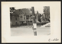 [recto] Sacramento, Calif.--Scene in residential section of the Japanese quarter two days before evacuation. Note Civilian Exclusion Order posted on telephone pole. Note also crated furniture on porch of corner house. ;  Photographer: Lange, Dorothea ;  Sacra