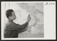 [recto] 1st Lt. Shigeru Tsubota points out where he was serving in Italy with the 100th Battalion. Lt. Tsubota is a ...