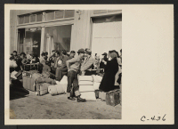 [recto] San Francisco, Calif. (2020 Van Ness Ave.)--Young evacuees of Japanese ancestry awaiting evacuation bus which will take them to an assembly center. They are part of the first contingent to be evacuated from San Francisco. ;  Photographer: Lange, Dorothe