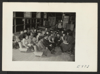 [recto] A story hour in a nursery class conducted by (right ) Miss Sumi Kashiwagi. ;  Photographer: Parker, Tom ;  Amache, Colorado.