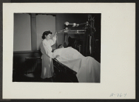 [recto] Hospital. View in X-ray Laboratory. Mrs. Mabel Shigaya, x-ray technician. Former occupation: x-ray technician. Former residence: Seattle, Washington. ;  Photographer: Stewart, Francis ;  Hunt, Idaho.