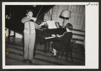 [recto] Social given by Omaha Y.M.C.A. for the evacuees. Entertainment hour. Violinist, Theodore Kanamine, age 14. Accompanist, Mrs. Walter N. Parmeter. ;  Photographer: Okano, Tom K. ;  Kansas City, Missouri.