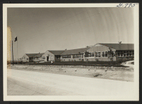 [recto] The Amache High School building looking towards the front from the south and west. ;  Photographer: McClelland, Joe ;  Amache, Colorado.