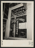 [recto] Los Angeles, Calif.--Last call to pick suits and gowns before shades were pulled down in Little Tokyo prior to evacuation of residents of Japanese ancestry. Many were assigned to Manzanar, War Relocation Authority center, in Owens Valley, California. ;