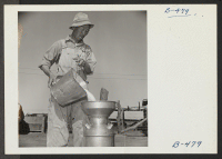 [recto] S. Ishimoto, former resident of El Centro, California, is shown at the dairy farm school here. He will be the milk barn foreman as soon as it has been completed, but now is helping to train evacuee students. At El Centro, he owned and operated a 200 cow d