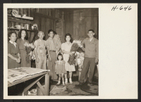 [recto] The Hideo Satow family, first returnees to Hawthorne (near Los Angeles), take time out from their work in their flower ...