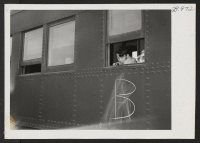 [recto] Boy accompanying his parents to the Tule Lake Center looks out a window of the special train which carried 254 transferees from the Minidoka Relocation Center. ;  Hunt, Idaho.