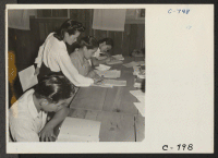 [recto] Manzanar, Calif.--Part of a class under the Adult Education Program at this War Relocation Authority center. Miss Doris Nakagawa, 25, ...