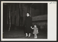 [recto] Issei and Sansei go for a walk. Mrs. Umeo Tatsukawa, formerly of Hanford and Jerome Relocation Center, takes her granddaughter, ...