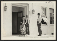 [recto] Buddhist Hostel, 1336 W. 36th Place, Los Angeles, showing (left to right): Mrs. Chiyo Okamoto (Amache), Rev. Imamura's little son ...