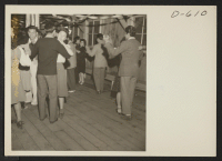 [recto] Dance in the social hall at this War Relocation Authority center where evacuees of Japanese ancestry are spending the duration. ;  Photographer: Stewart, Francis ;  Manzanar, California.
