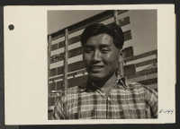 [recto] Typical Nisei family man engaged in delivering mess hall provisions at relocation center. ;  Photographer: Parker, Tom ;  Topaz, Utah.