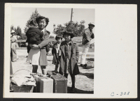 [recto] Turlock, Calif.--These children have just arrived at Turlock assembly center. Evacuees of Japanese ancestry will be transferred later from assembly points to War Relocation Authority centers where they will spend the duration. ;  Photographer: Lange, Do