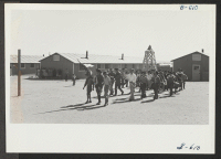 [recto] Evacuees staging a Boy Scout Memorial Day Service on May 30. ;  Photographer: McClelland, Joe ;  Amache, Colorado.