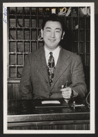 [recto] Greeting travelers in a Bridgeport, Connecticut hotel is Ken Hayashi, former newspaper correspondent and gas station operator from Tacoma, Washington. ...