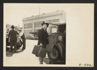 [recto] San Francisco, Calif. (2020 Van Ness Ave.)--Evacuees of Japanese ancestry arriving at the WCCA station to await evacuation bus which will take them to the assembly center. ;  Photographer: Lange, Dorothea ;  San Francisco, California.
