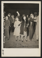 [recto] Los Angeles, Calif.-- Waving to departing friends who are leaving for assembly centers. All residents of Japanese ancestry from designated military areas will eventually be housed in War Relocation Authority Centers to spend the duration. ;  Photographe