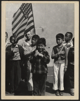 [recto] Raphael Weill Public School, Geary and Buchanan Streets. Young Americans salute the flag in the playground. ;  San Francisco, California.