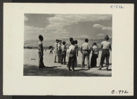[recto] Manzanar, Calif.--Baseball is the most popular recreation at this War Relocation Authority center with 80 teams having been formed throughout the Center. Most of the playing is in the wide fire-break between blocks of barracks. ;  Photographer: Lange, D