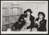 [recto] Newly arrived from Tule enjoying refreshments at midnight. ;  Topaz, Utah.