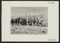 [recto] Manzanar, Calif.--Farm crew of which Johnny Fukazawa is foreman. These men are ready to return to the center's mess hall for lunch after a busy morning in the fields of the farm project at this War Relocation Authority Center. ;  Photographer: Lange, Do