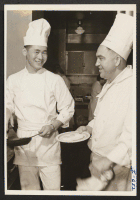 [recto] Mr. Masao Dobashi and Mr. Orville Lowery are shown at their work as cooks in the coffee shop of the ...
