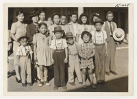 [recto] Shown are some arrivals in Madera, California, from the Rohwer Relocation Center. ;  Photographer: Iwasaki, Hikaru ;  Madera, California.