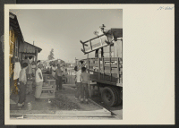[recto] Closing of the Jerome Center, Denson, Arkansas. Scene as household furnishings were loaded in trucks for movement to the Rohwer Center. Practically all the furniture in the center is home made from plain scrap lumber salvaged from the center's sawmill.
