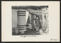 [recto] Makeshift closet in barracks at this assembly center. Persons of Japanese ancestry were housed temporarily in such centers before being transferred to relocation centers. ;  Photographer: Albers, Clem ;  Salinas, California.