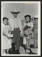 [recto] Mrs. Ohmura and Father Dai bid goodbye to Mae Ohmura who leaves for work on the outside. ;  Photographer: Cook, John D. ;  Newell, California.