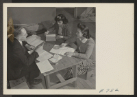 [recto] Miss Mary Saito and Miss Alice Yamaoka, young Nisei residents at the Granada Relocation Center, register for defense employment with ...