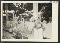 [recto] Trayscape and flower display at the Amache Agricultural Fair held September 11 and 12. ;  Photographer: McClelland, Joe ;  Amache, Colorado.