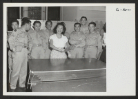 [recto] Enjoying a game of ping-pong at the Washington USO for Nisei servicemen and their guests is Yvonne Noguchi, Minidoka, one ...