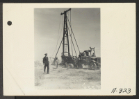 [recto] Parker, Ariz.--Lieutenant Commander Ralph B. Snavely of the U.S. Public Health Service watches well-digger bore for fresh water at War Relocation Authority center for evacuees of Japanese ancestry on Colorado River Indian Reservation. ;  Photographer: A