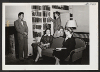 [recto] In the living room at Pendle Hill, a Quaker graduate school at Wallingford, Pennsylvania. From left to right: Jyuichi Sato, ...
