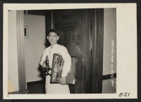 [recto] Los Angeles, Calif.--Dr. Tom T. Watanabe, Physician and Surgeon of Japanese ancestry, by his office door prior to evacuation of residents of Japanese descent from military areas. Evacuees are being housed in War Relocation Authority centers for the durati