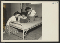 [recto] Closing of the Jerome Center, Denson, Arkansas. Three young ladies of the Jerome Relocation Center exchange addresses before leaving to ...