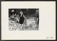 [recto] Evacuee workers in the packing shed, sorting and packing turnips which have been grown on the farm near this relocation center. ;  Photographer: Stewart, Francis ;  Newell, California.