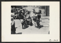 [recto] Turlock, Calif.--These evacuees of Japanese ancestry have just arrived at this Assembly Center and are awaiting the inspection of their ...