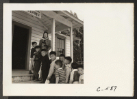 [recto] Tanforan Assembly Center, San Bruno, Calif.--Preschool evacuee children at this assembly center number 25 with six volunteer student teachers being trained by a Mills College graduate, all of Japanese ancestry. ;  Photographer: Lange, Dorothea ;  San